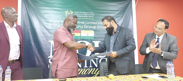 Kwadwo Baah Agyemang (2nd from left), Chief Executive Officer, Ghana Digital Centre Limited (GDCL) and Mudunuru M.S. Raju (2nd from right), Managing Director of Mudunuru Group exchanging documents after the signing ceremony. Looking on are Aloysius Adjetey(left), Board member,GDCL, and M. Chandrashekar (right), Director, Global Business, Mudunuru Group. Picture: EDNA SALVO-KOTEY
